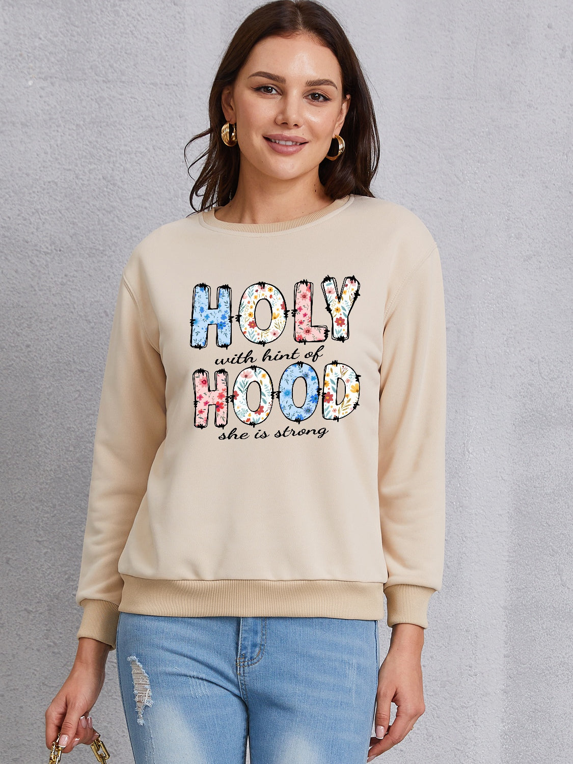 HOLY WITH HINT OF HOOD SHE IS STRONG Round Neck Sweatshirt